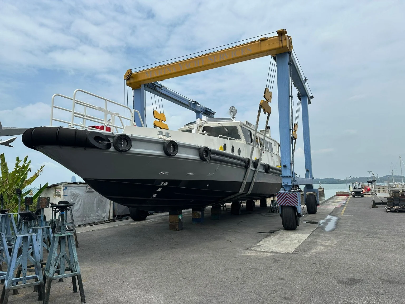 Heavy commercial vessel on a travel lift in a marine yard