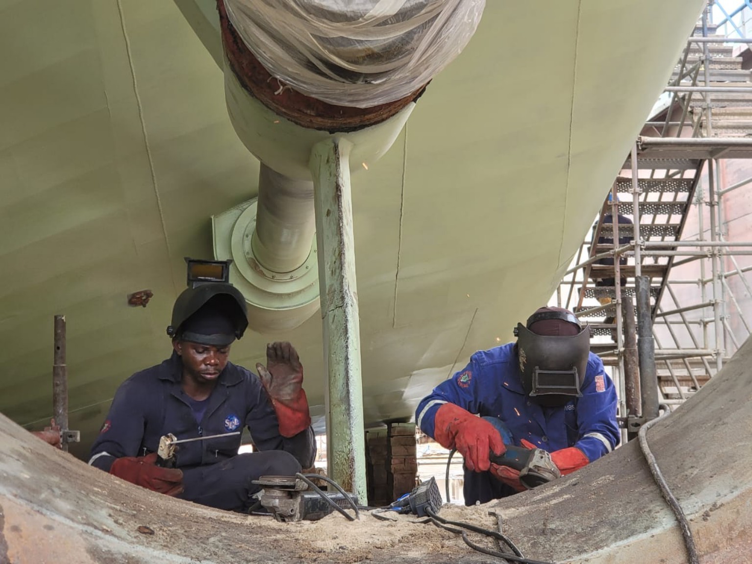 Technicians working beneath a vessel